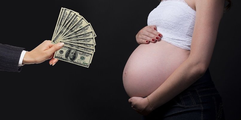 Pregnant woman receiving money