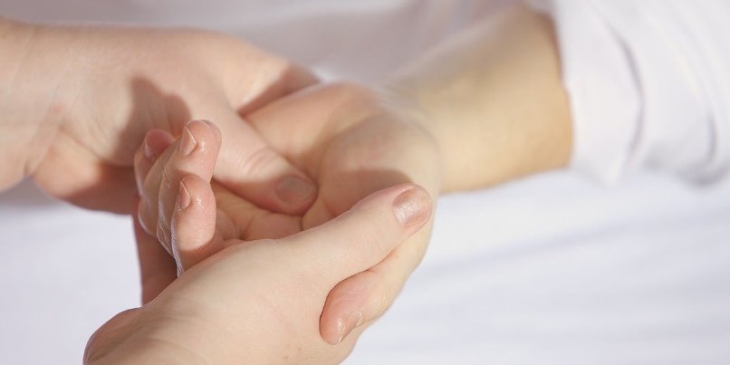 Therapist giving Hand Massage and Reflexology