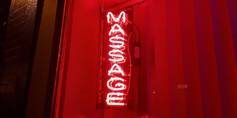 Outdoor neon sign of a massage parlor