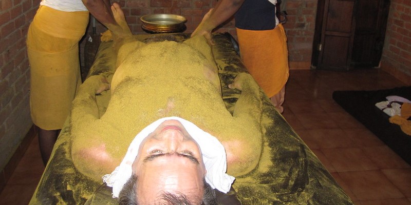 Man receiving Ayurvedic Udvartana Massage