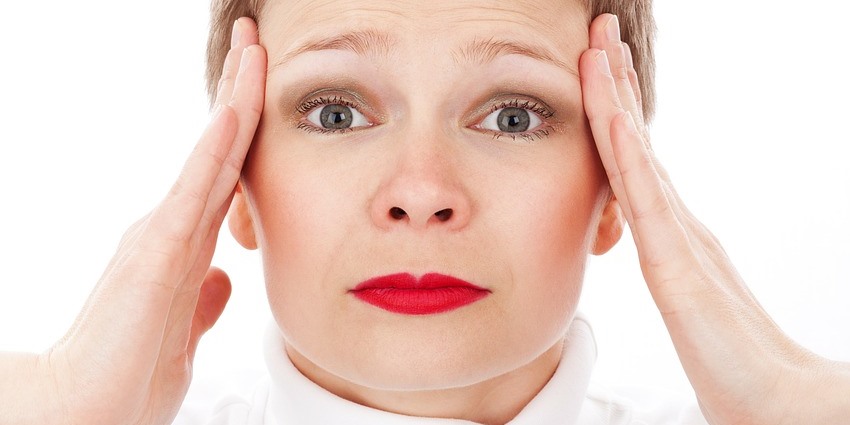 Woman giving face self-massage