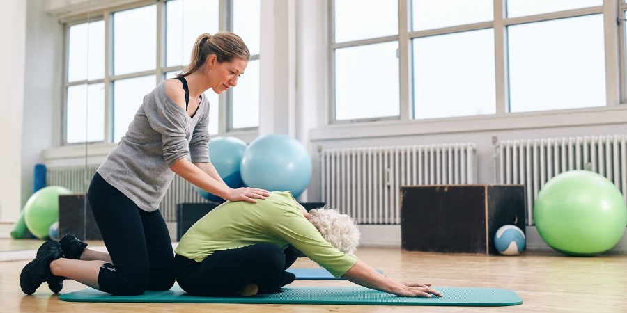 Therapist giving Yoga Therapy to older woman