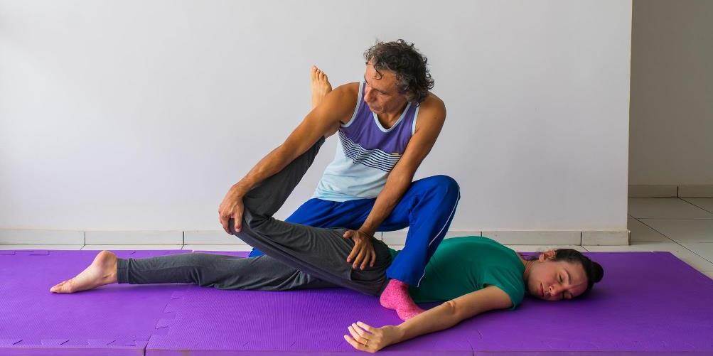 Thai masseur giving massage to client