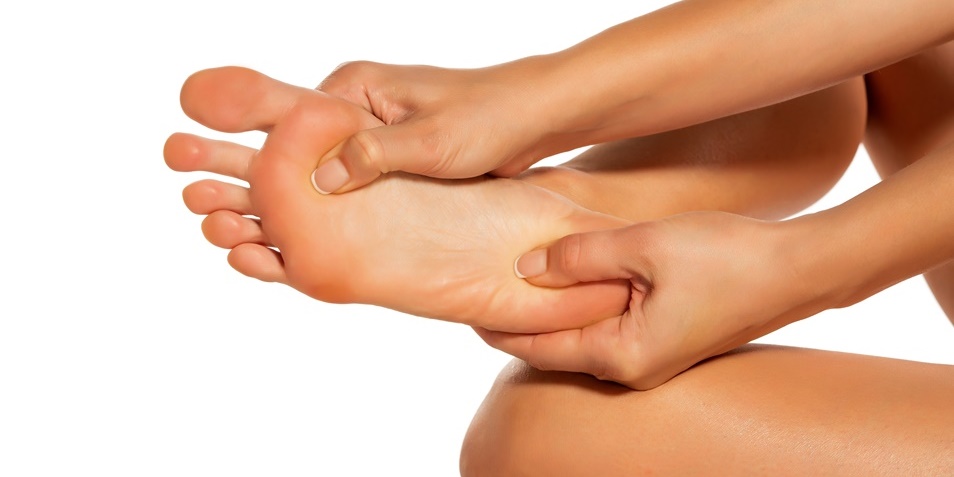 Woman giving self-massage to the foot