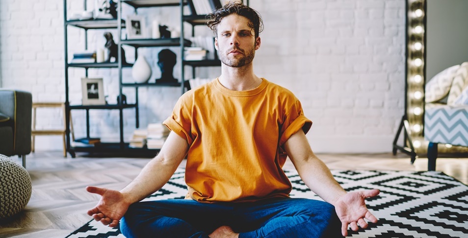 Man doing breathwork sitting in a room