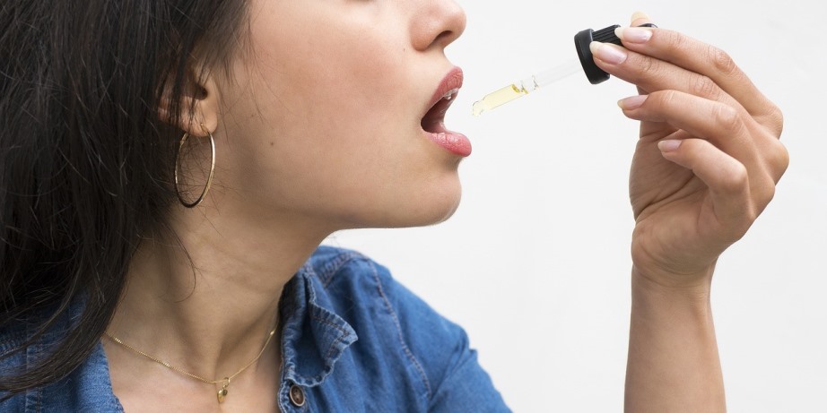 Woman consuming CBD oil