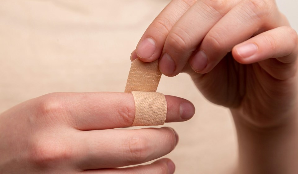 Person with band-aid around finger