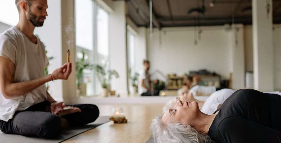 Yoga teacher guiding meditation session