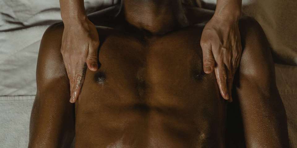 Man receiving erotic genital massage