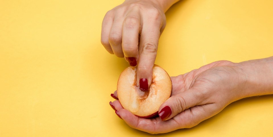 Woman fingering fruit