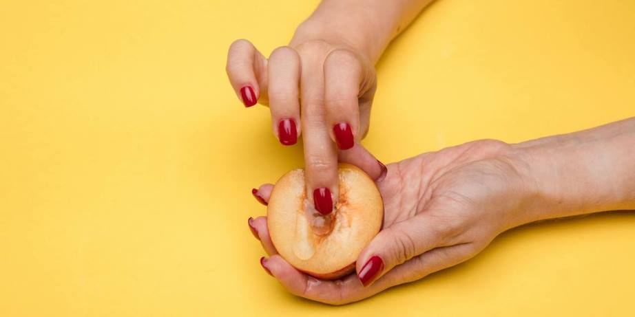 Woman fingering peach