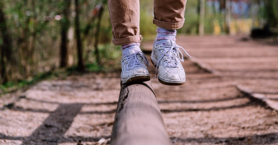 person keeping balance on a balance bar