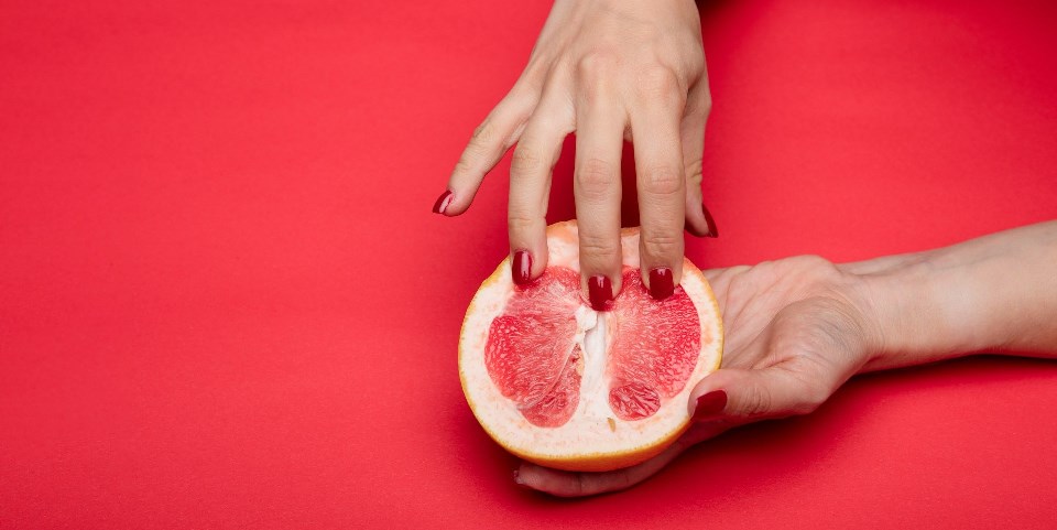 Woman fingering a fruit