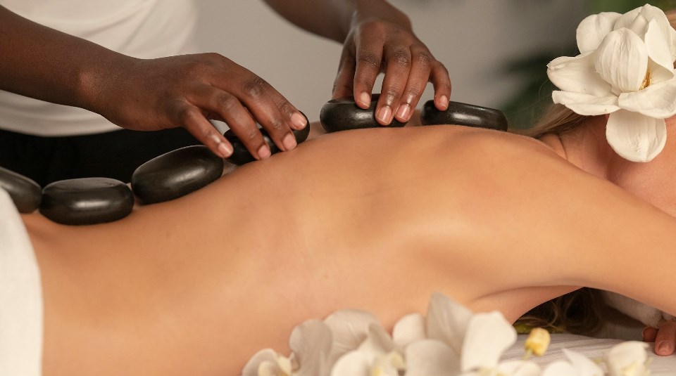 Woman receiving hot stones massage