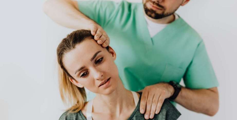 Massage therapists testing client range of motion and pain