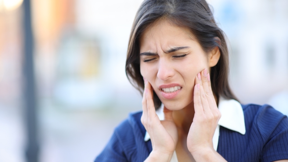 Woman suffering from jaw pain