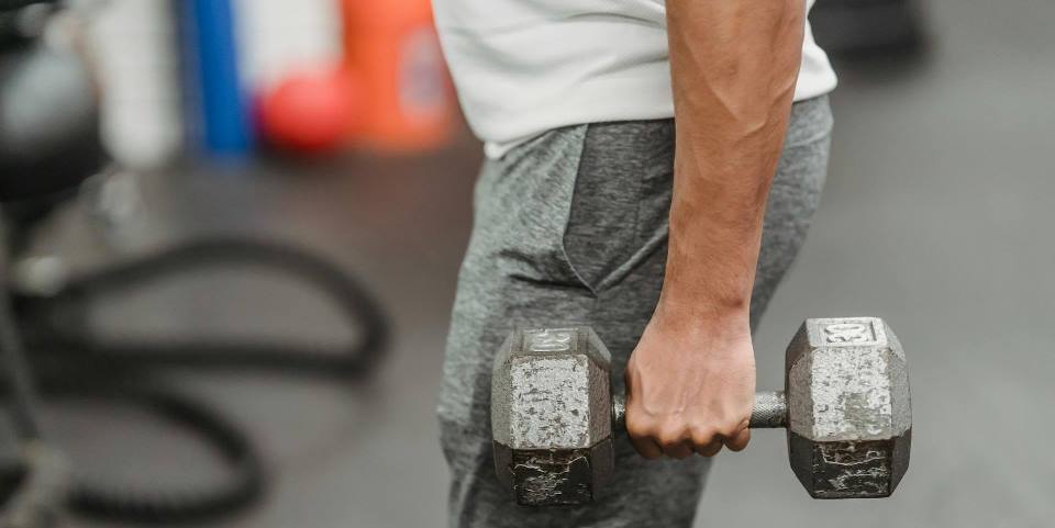 Sportsman training with dumbbells