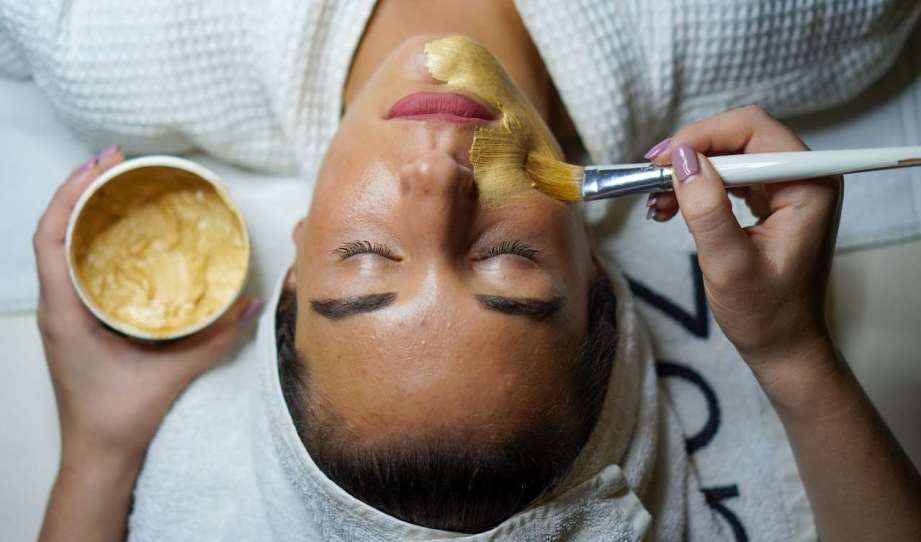 Woman having facial mask
