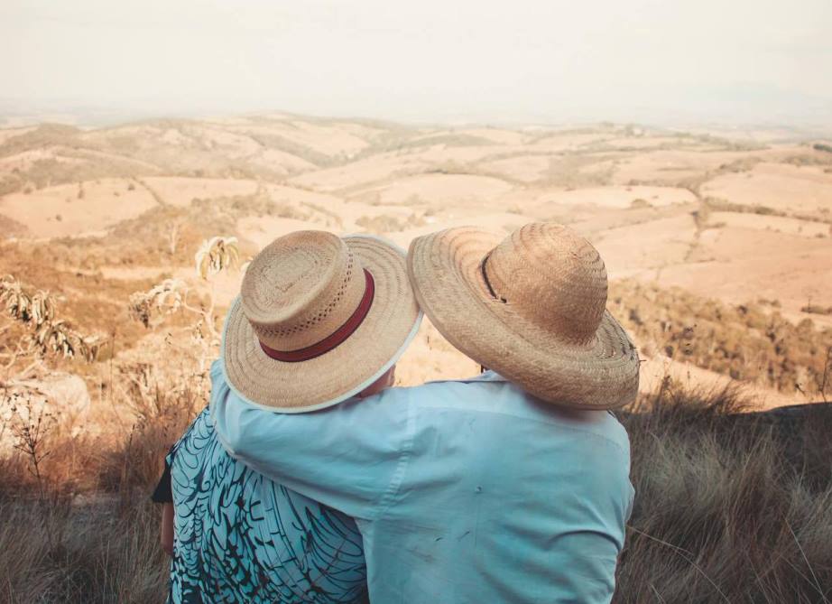 Two persons wearing sunhats