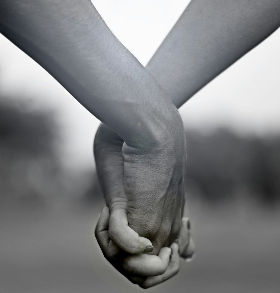 Two persons holding hands