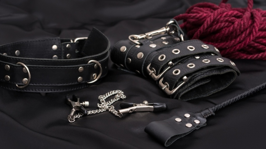 BDSM collar, whip, rope, and nipple clamps