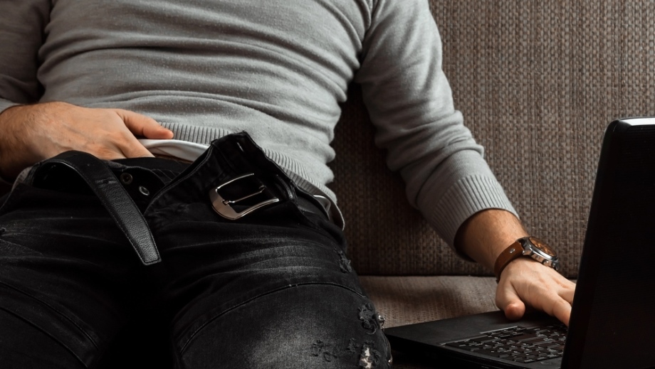 Man masturbating in front of laptop