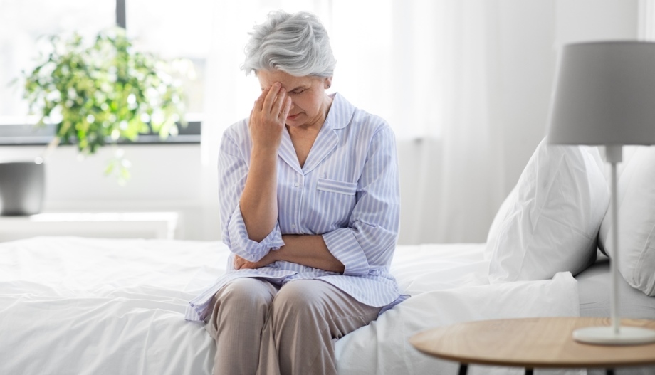 Depressed senior woman in bedroom