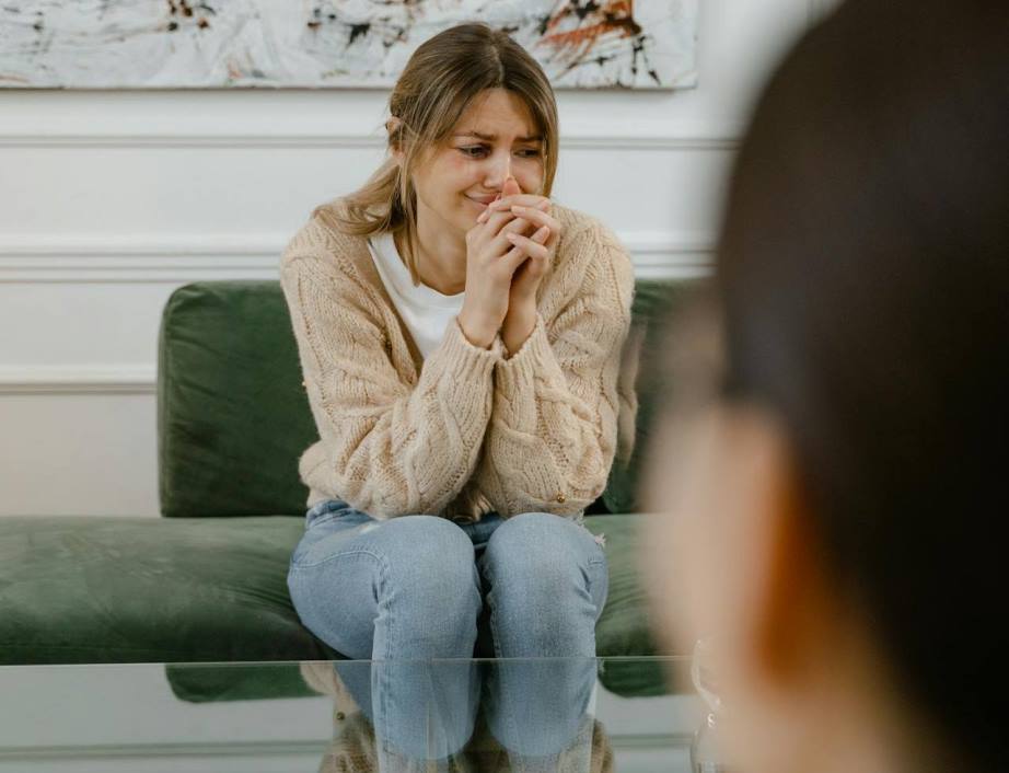 Sad woman sitting on couch