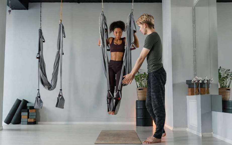 Yoga instructor beside a woman