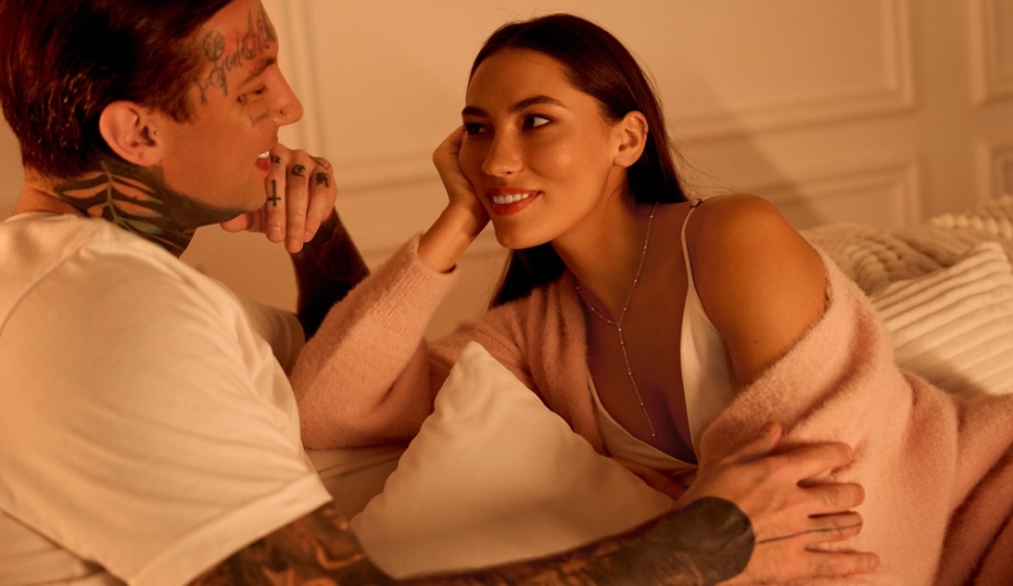 Two friends having intimate conversation in bed