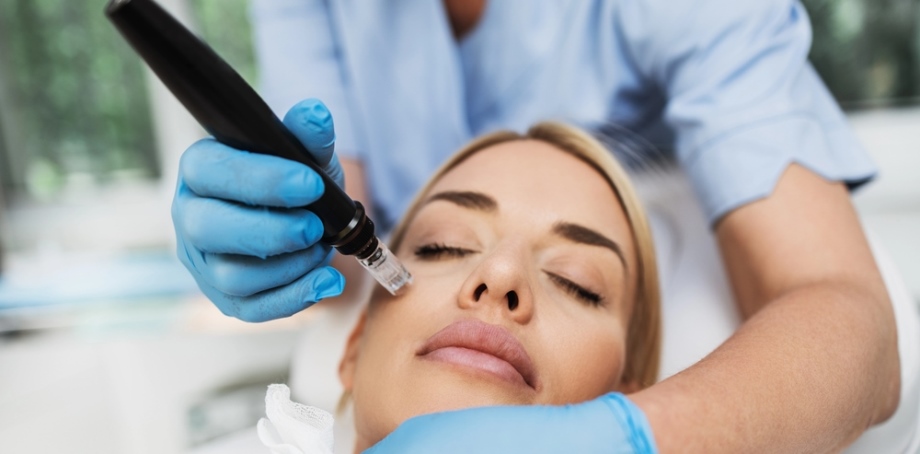 Woman receiving microneedling session