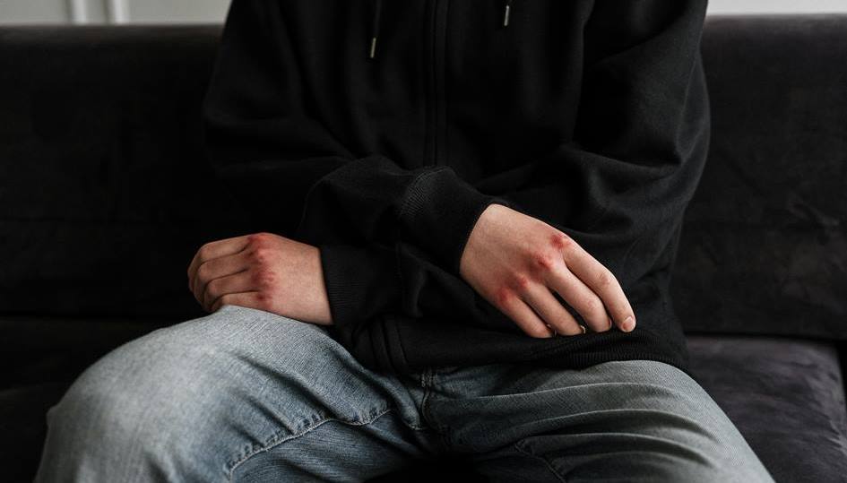 Traumatized man sitting on couch in trauma healing session