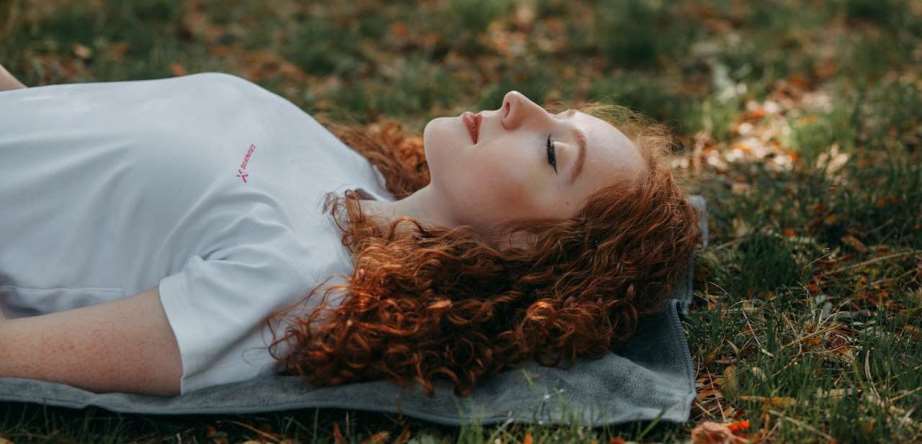 Woman relaxing while laying on the ground