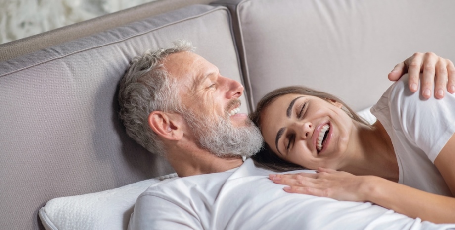 Older-younger couple in bed 