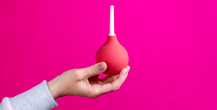 Anal Douche Explained | Enema Bulbs Hand holding anal douche equipment