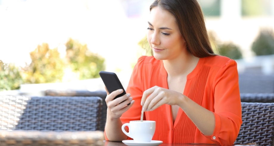Woman stirring cup of coffee