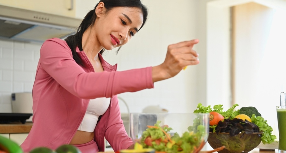 Woman squeezing lemon while paying attention
