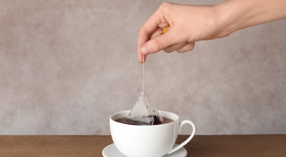 Dipping teabag in cup of hot water