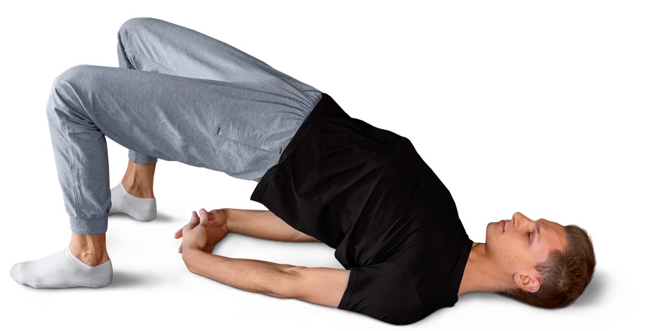 Man performing yogic bridge pose for prostate health