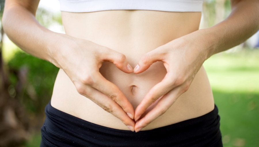 ILU Technique: The I Love You Abdominal Massage Woman with love gesture on abdomen