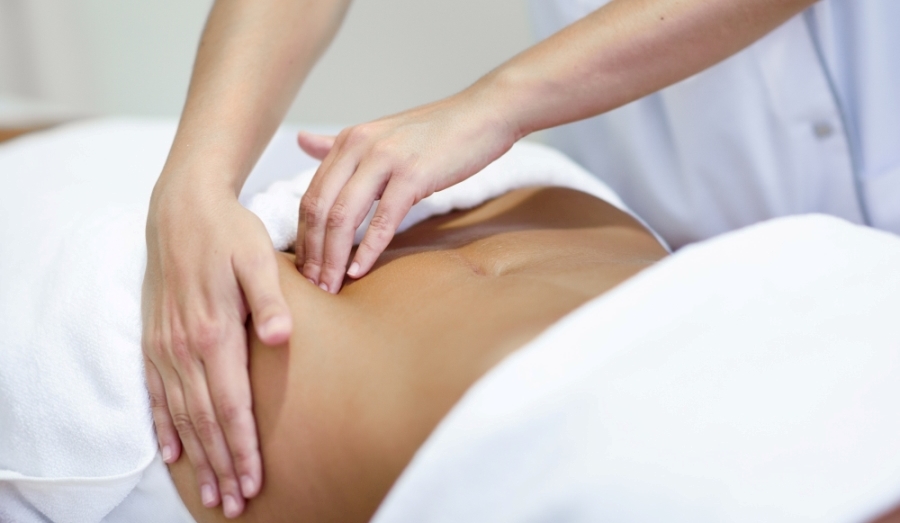 Abdominal Myofascial Release (AMF) Woman receiving abdominal treatment