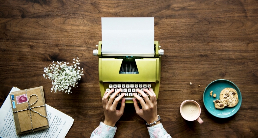 Write For Us: Health, Bodywork & Sensual Wellness Guest Post Guidelines Top view of a woman typing on a retro typewriter blank paper